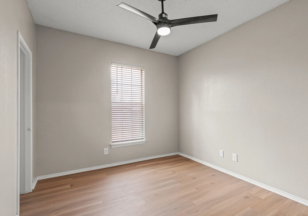 Bright bedroom with wood-style flooring